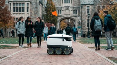 Starship delivery robot crossing a university campus path